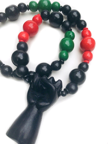 Hand carved wooden fist necklace red black green pan African black power fist redemption